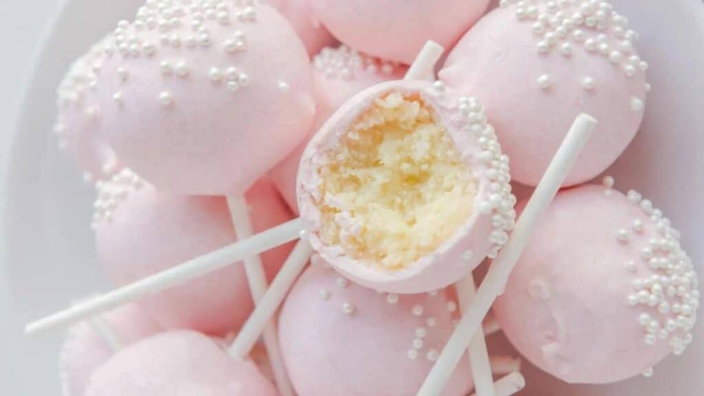 A pile of cake pops on a plate.