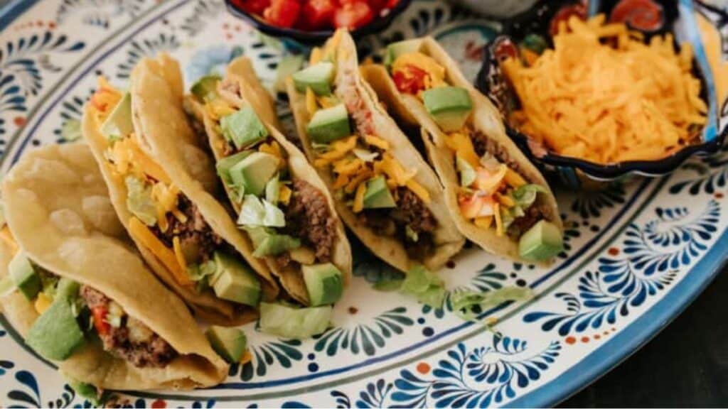Tacos on a blue and white plate.