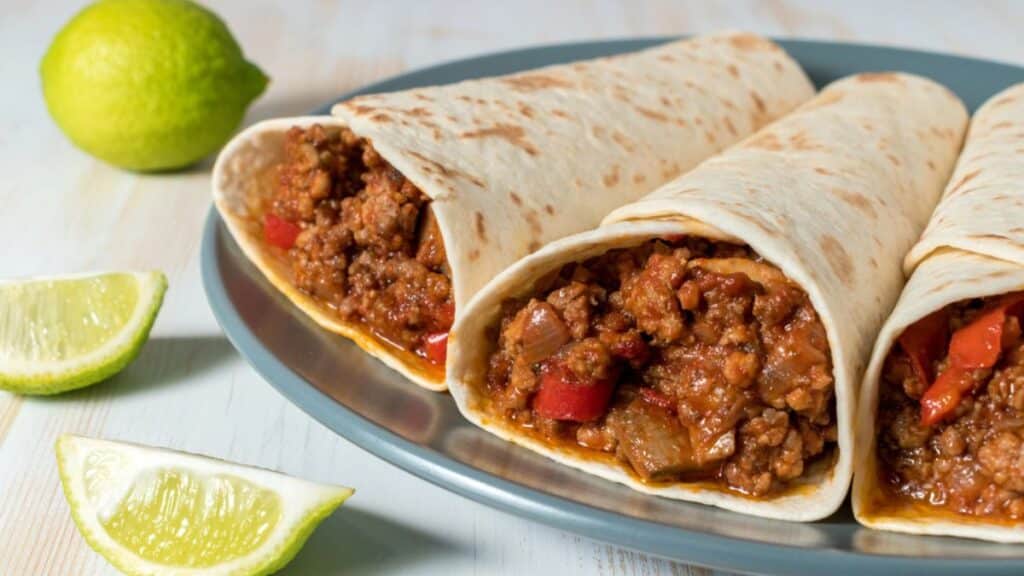 Beefy frito burritos on a plate.