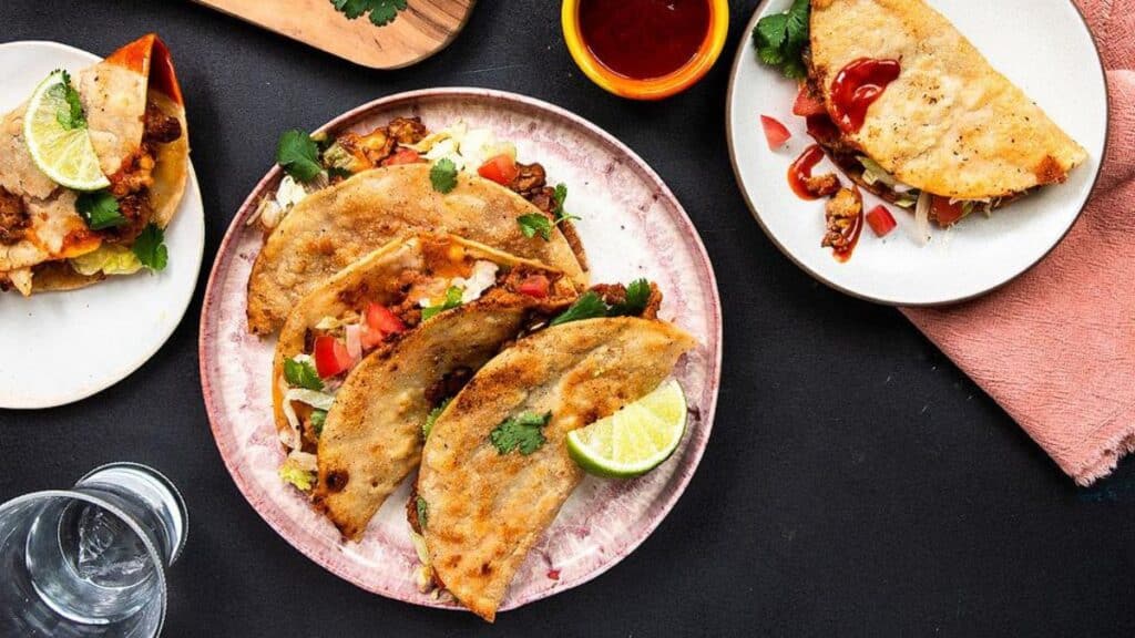Turkey tacos on a plate with a dark background.