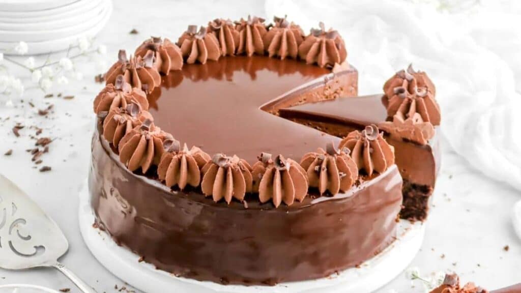 Dark Chocolate Mousse Cake with frosting on a white background.