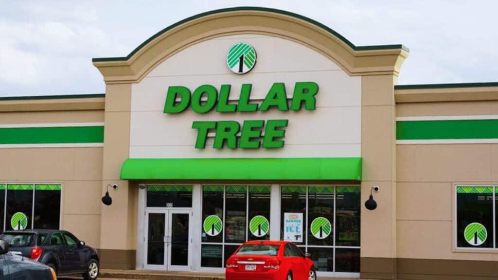 Outside of Dollar Tree building with red car parked in front.
