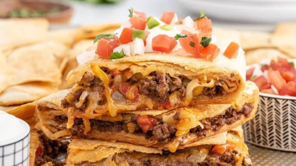 Sheet Pan Tacos stacked up next to bowl of salsa.