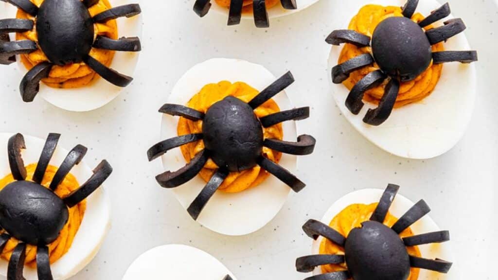 Olive spider Deviled Eggs on a white background.