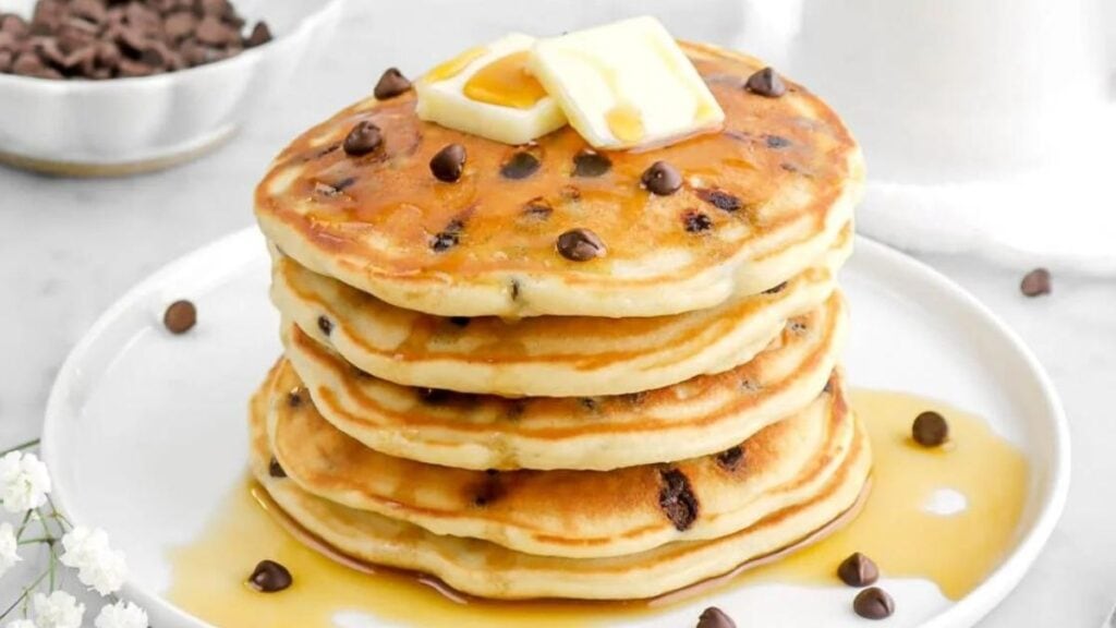 Chocolate chip pancakes on a white plate.