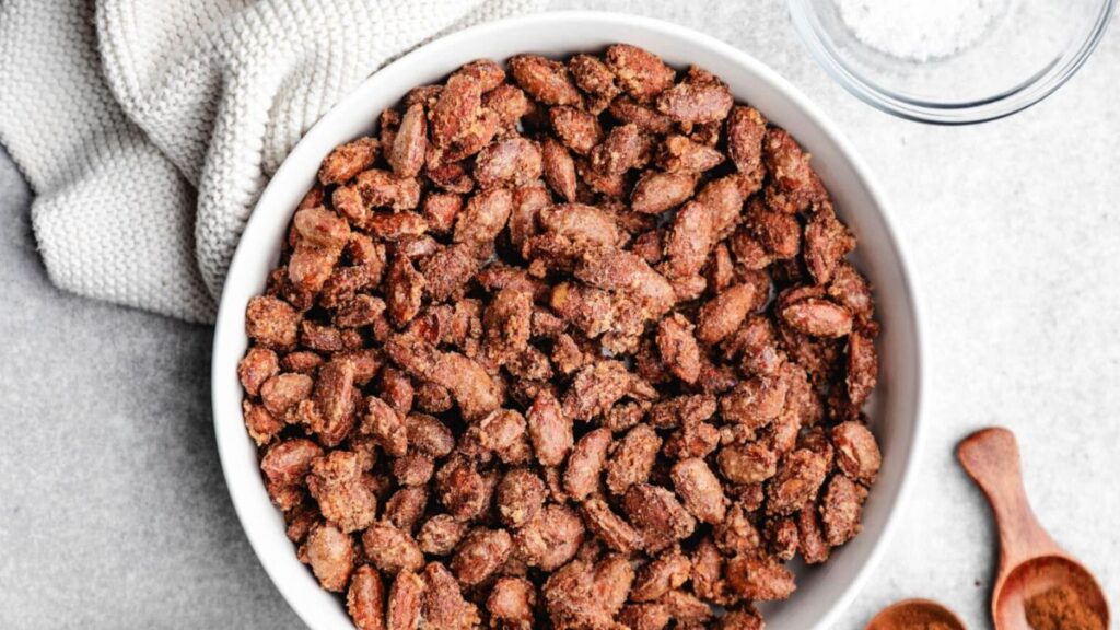 Candied almonds in a white bowl.