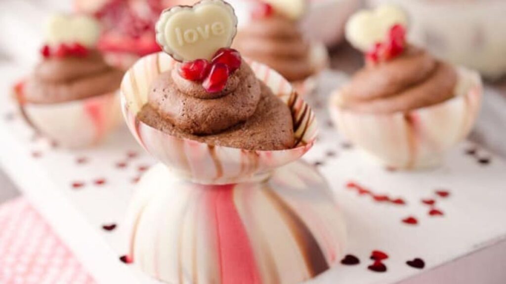 Chocolate mousse bowls with pomegranates over the top.