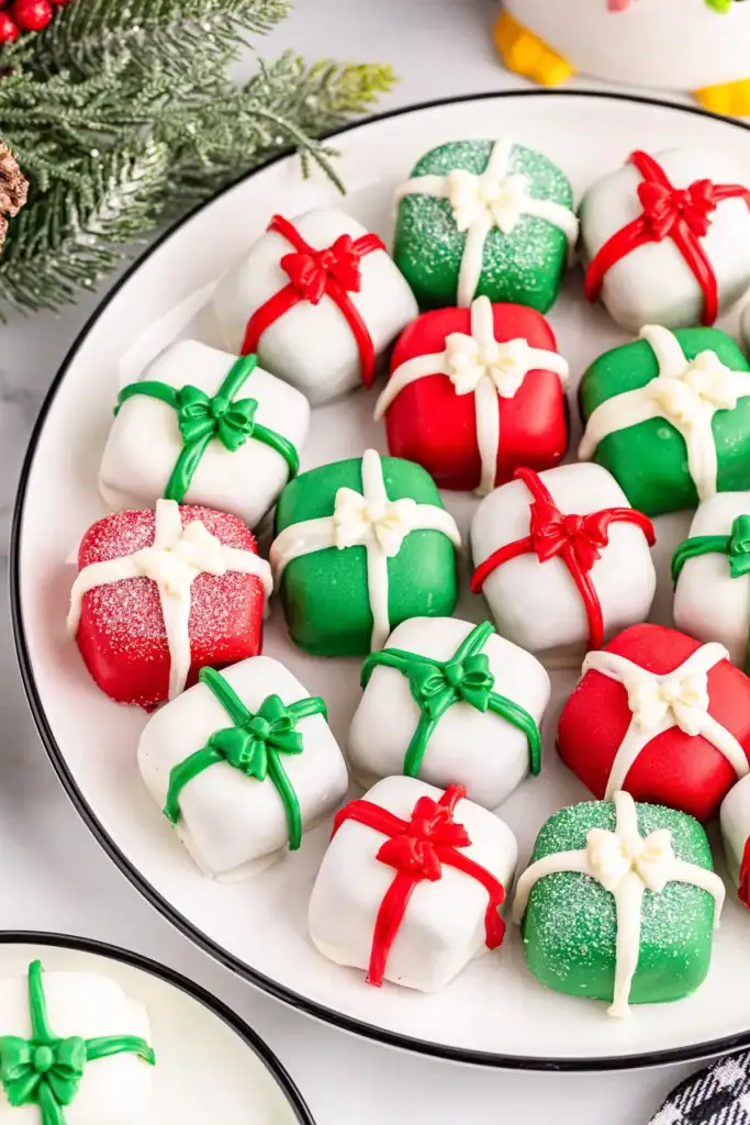 Christmas present truffles on white plate.