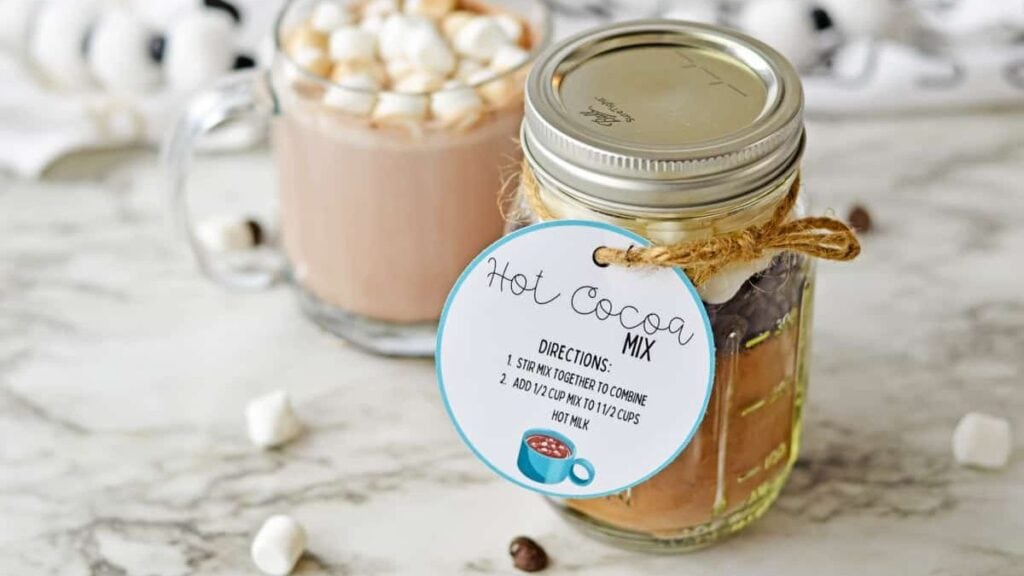 Hot chocolate mix in jar on a marble background.