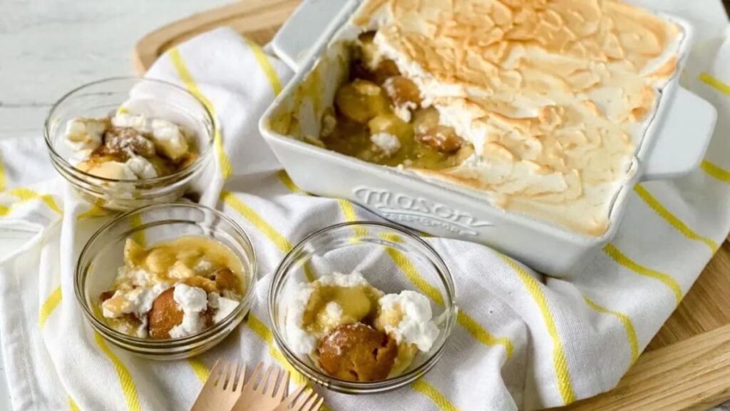 Banana pudding casserole baked in a white baking dish and served in bowls.