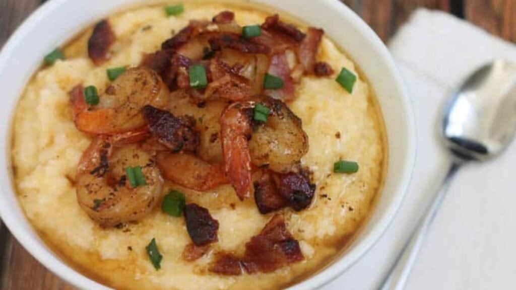 Shrimp and grits in a bowl on the table.