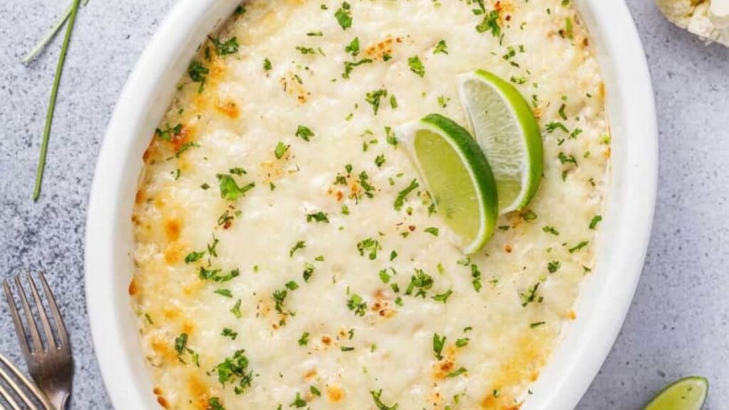A cheesy chicken and cauliflower rice casserole in a bowl.