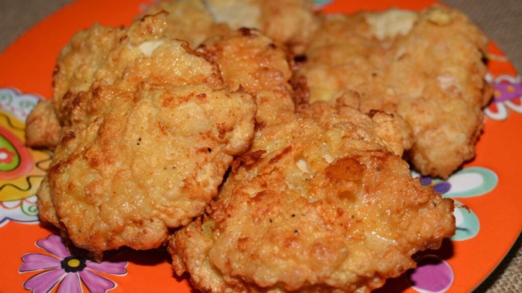 Chicken fried chicken on an orange plate.