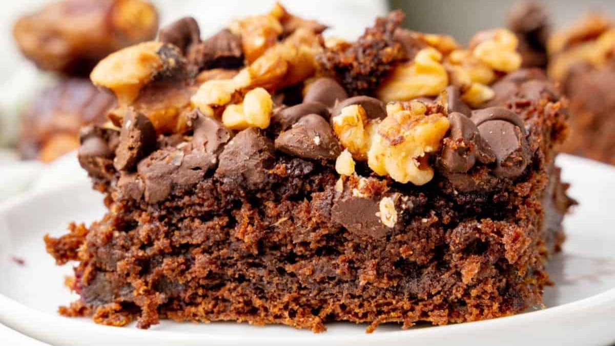 A slice of chocolate chip date cake on a plate.