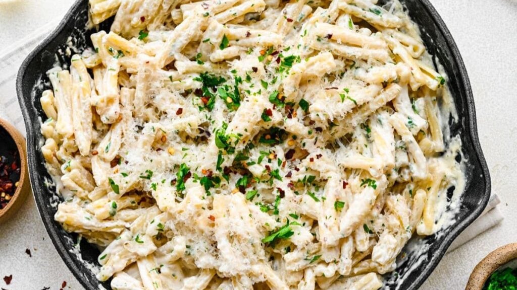 Cheesy pasta dish cooked in a skillet.