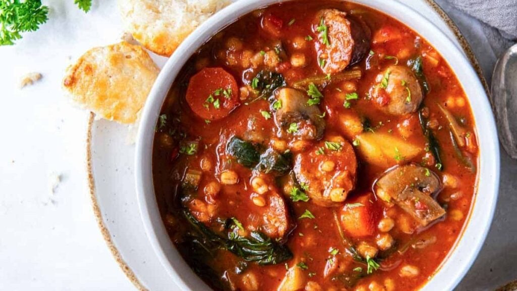 A bowl of Italian stew in a white bowl.
