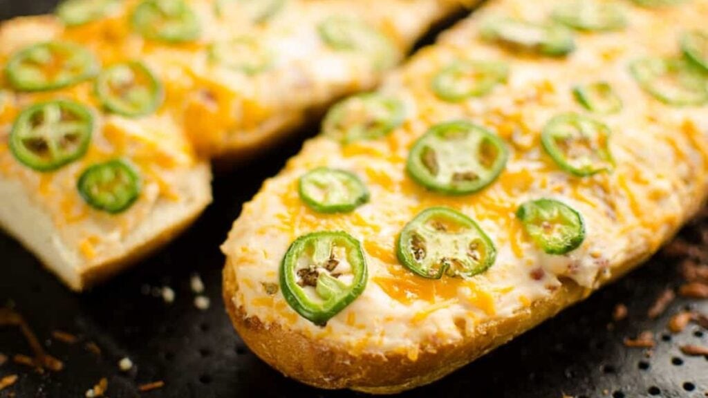 French bread topped with cheese and slices of jalapenos.