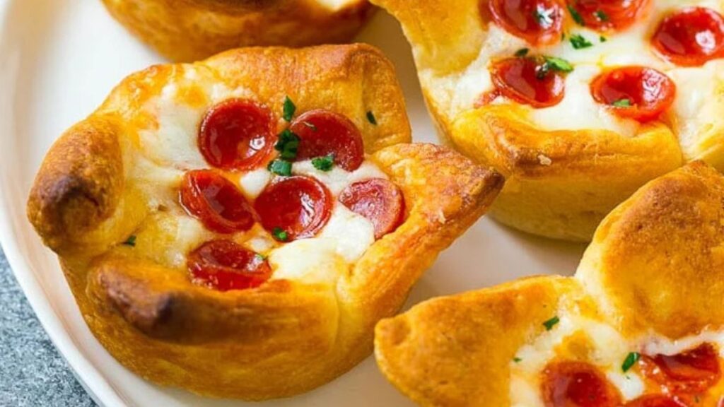 Pizza muffins on a white plate.