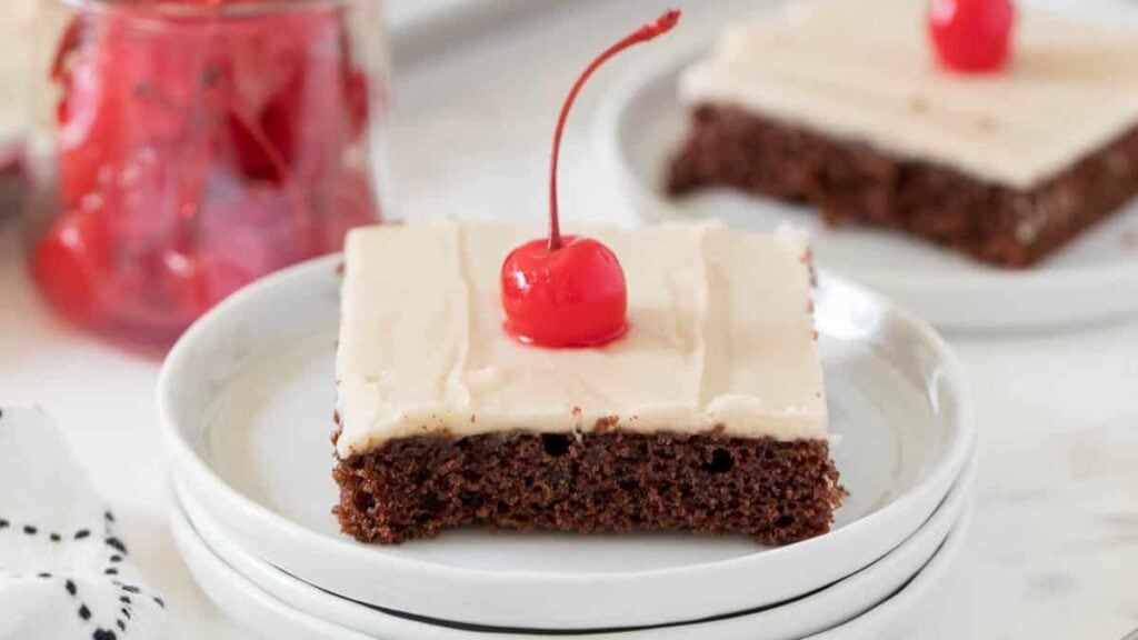 Sheet cake with a cherry on top. 
