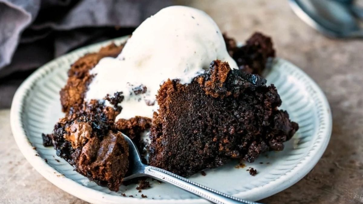 A slice of brownies with ice cream on top.