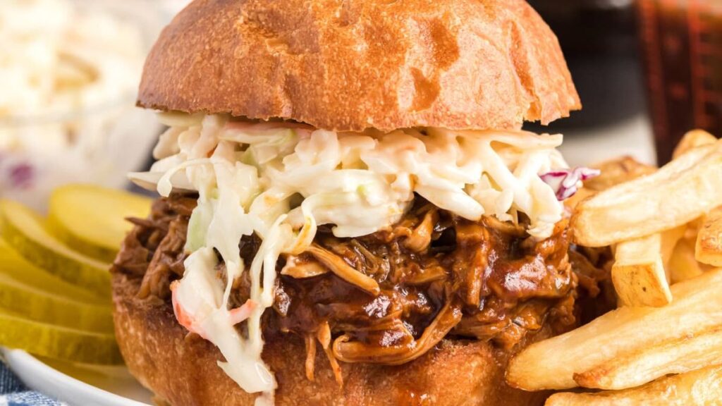 Pulled pork in buns with fries on the side.