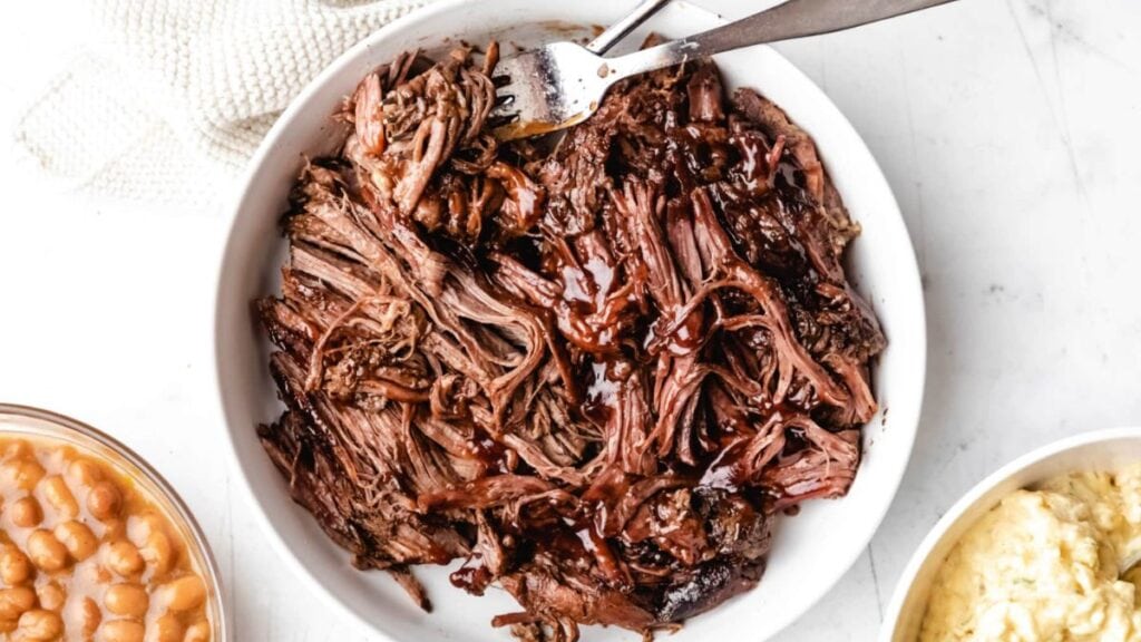 Beef brisket with on a white plate.