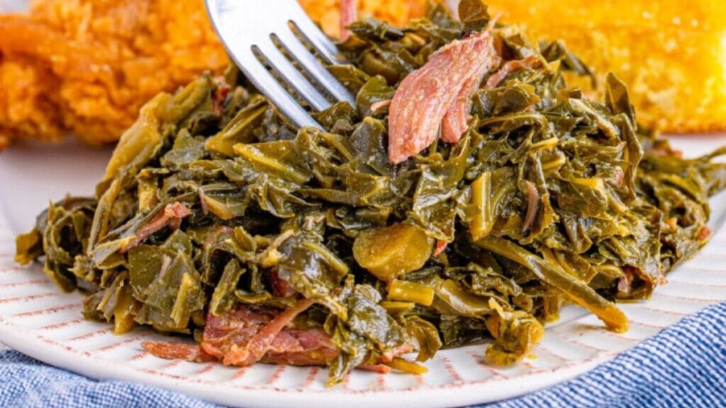 Collard greens and ham on a plate.