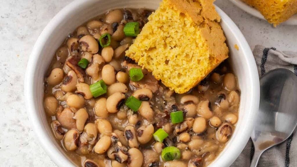 Black eyed peas with a piece of cornbread.