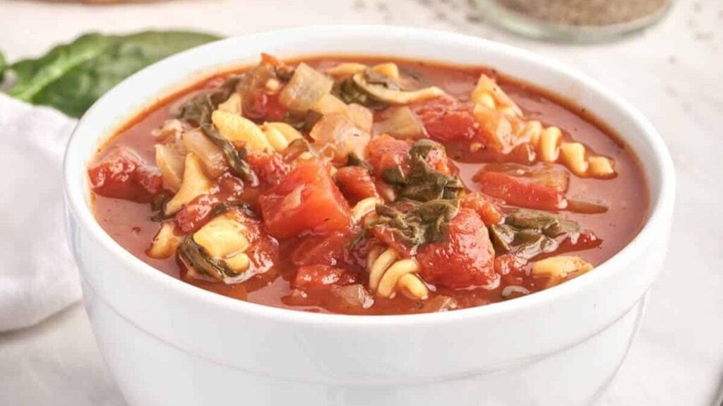 Tomato soup with vegetables in a bowl.