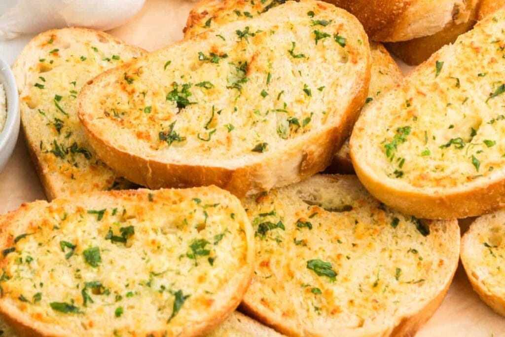 Seasoned garlic bread served on a plate.