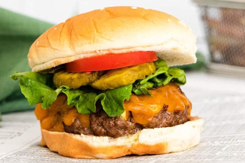 Hamburger patty with toppings and a bun.