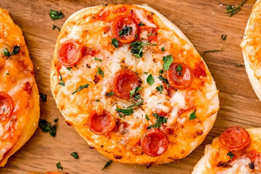 Air fryer pepperoni pizzas on wooden block.
