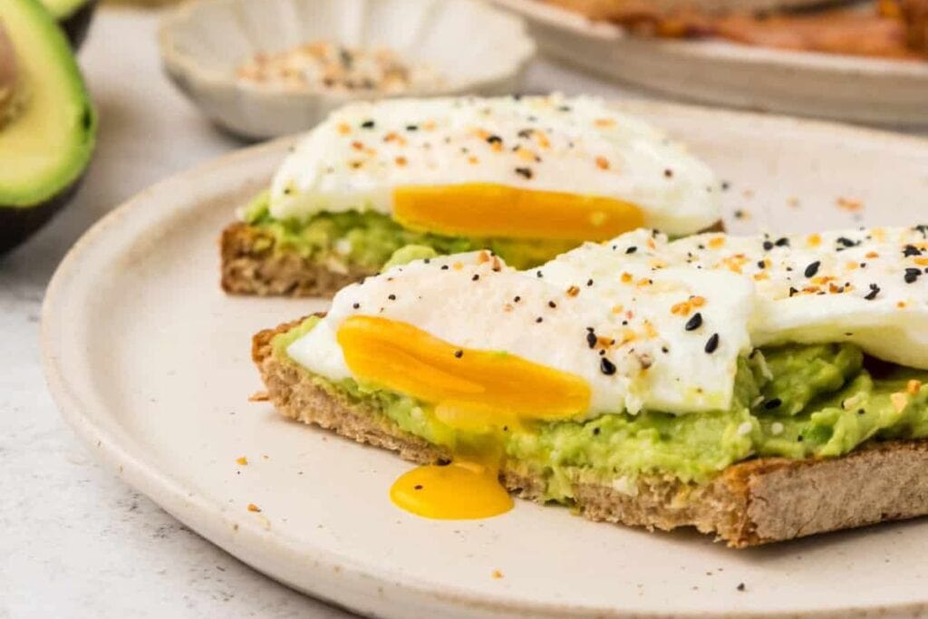 Toast topped with avocado spread and eggs.
