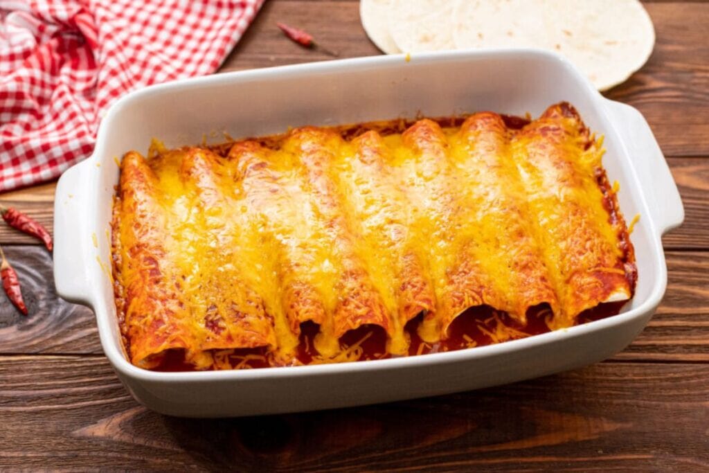 Cooked beef enchiladas in a baking dish.