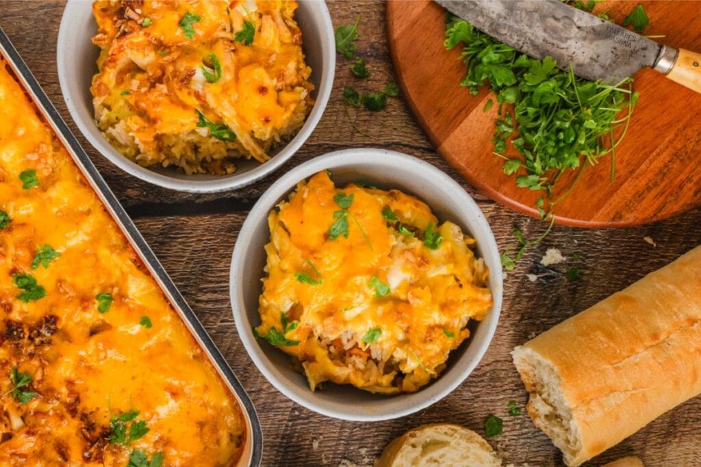 Two bowls of cheesy chicken and rice casserole.