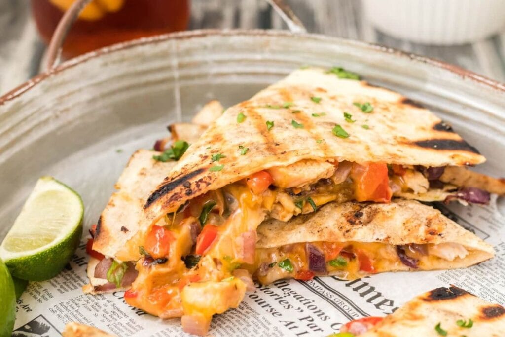 Grilled chicken and veggies inside a quesadilla.