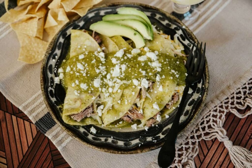 Pulled pork enchiladas with salsa verde on top.