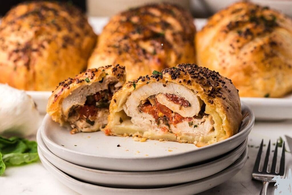 Bruschetta stuffed chicken breast on a plate.
