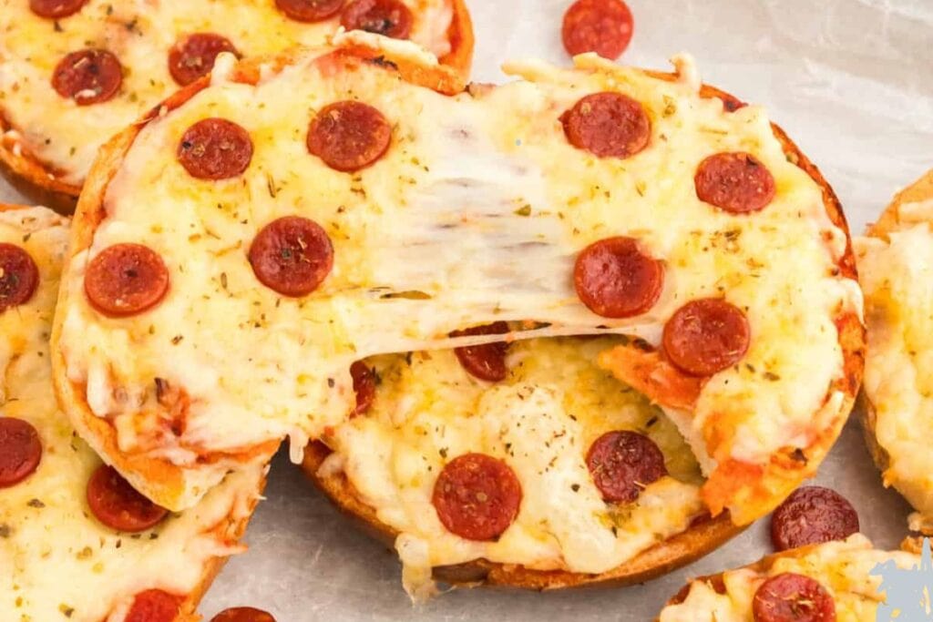 Pizza bagels with pulled cheese.