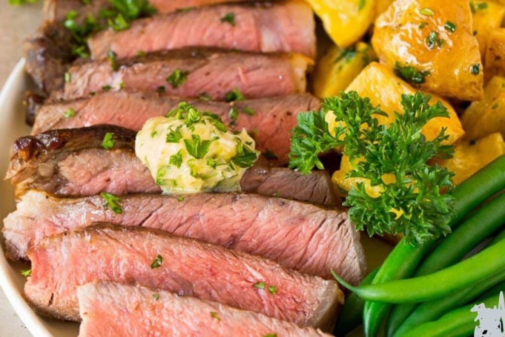 Sliced steak with garlic butter.