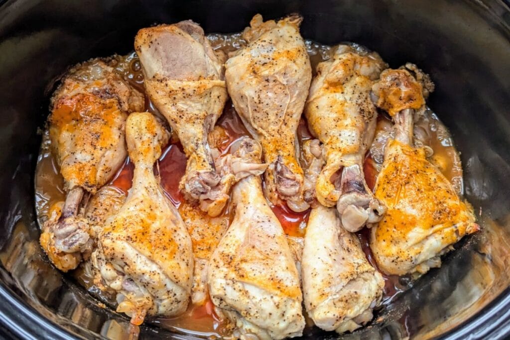 Chicken drumsticks in a slow cooker.