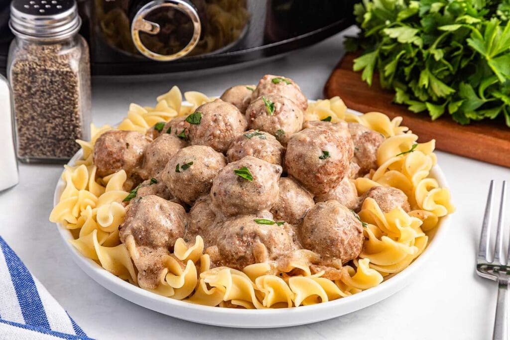 Swedish meatballs with pasta on a plate.