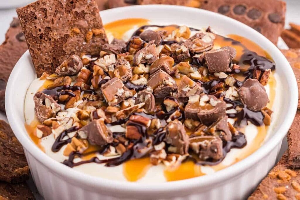 Turtle cheesecake dip in a bowl.