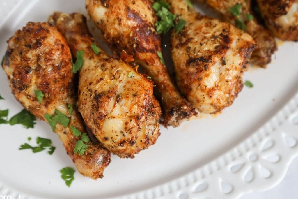 Chicken drumsticks on a plate.