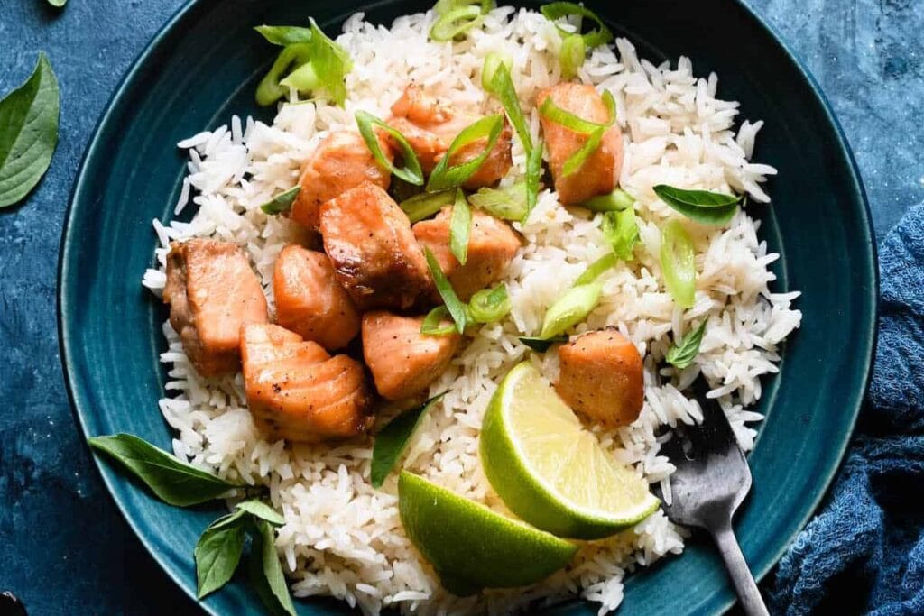 Salmon bites with rice in a bowl.