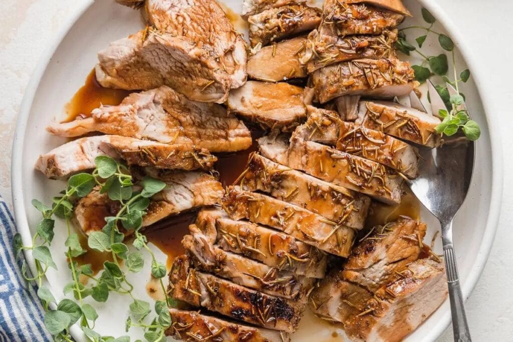 Sliced pork tenderloin on a plate.