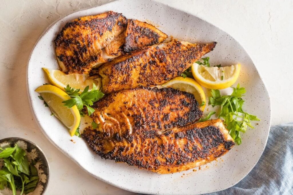 Blackened tilapia on a plate.
