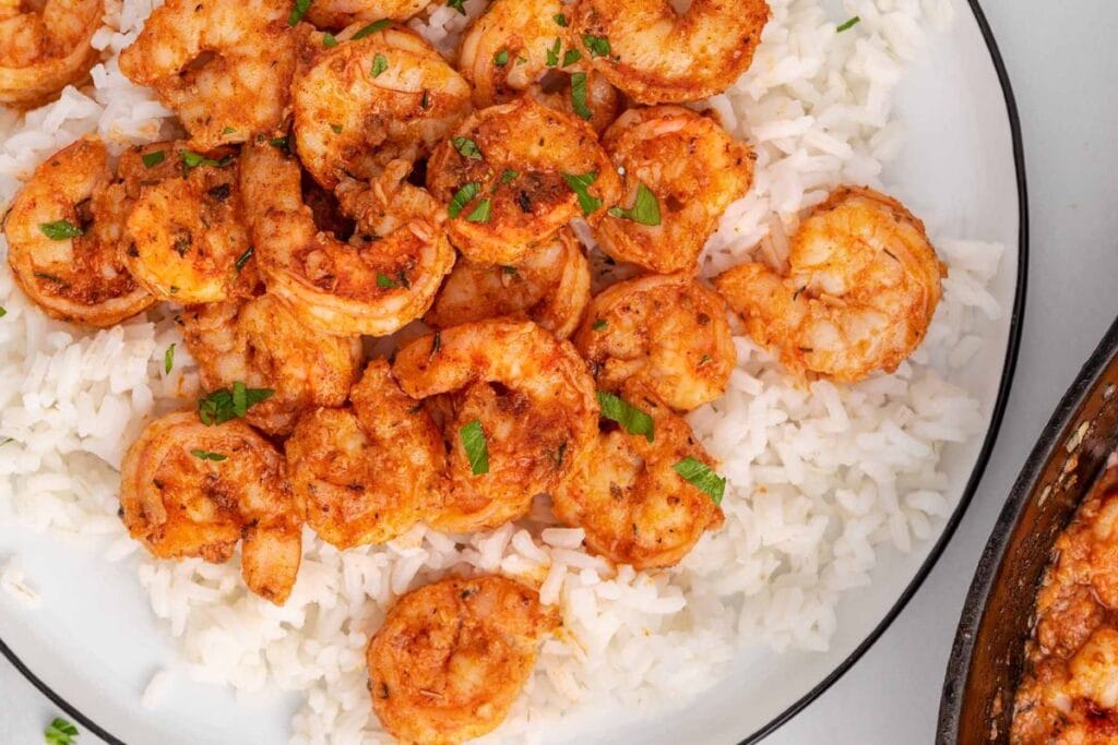 Cajun shrimp with rice on a plate.
