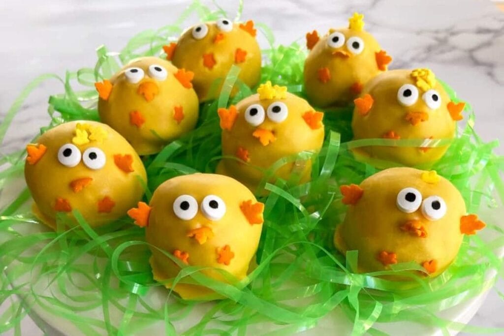 Chick cake pops on a plate.