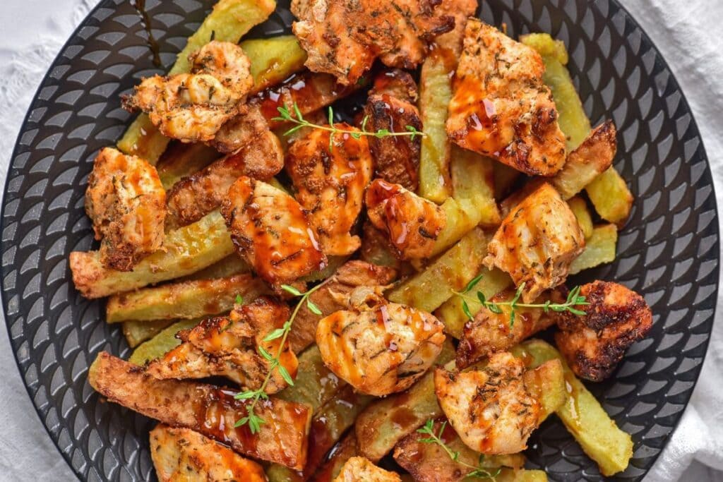 Chicken and potatoes on a plate.